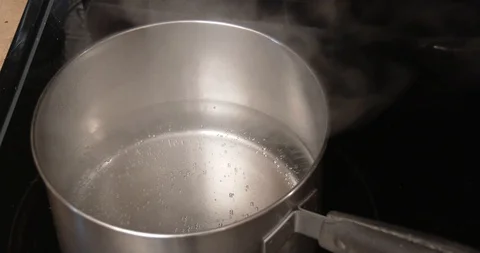 Pan of Water - Almost Boiling - A watched pot never boils Stock Footage 95615942