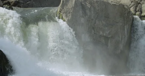 Pan up waterfall rapids in front of a cave in Great Falls Park Stock Footage 91901731