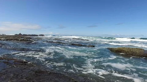 Pan of Waves Coming into Rocky Beach Stock Footage 87927331