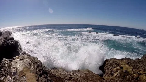 Pan of waves crashing on the beach Stock Footage 79573633
