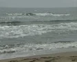 Pan from waves to quiet beach SD Footage