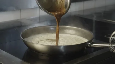 The pan on which the chef stirs the cream with a whisk and adds the ingredients. Video stock 236385803