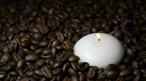 Pan on white candle on coffee beans Stock Footage 22105501