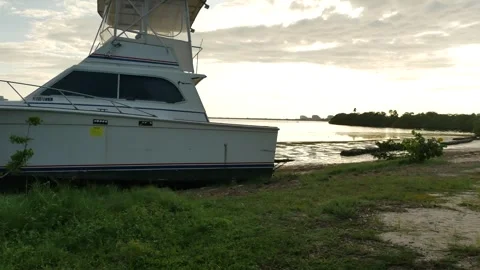 Pan Wide view out towards washed up on shore tall large blue and white Derelict Stock Footage 284732693