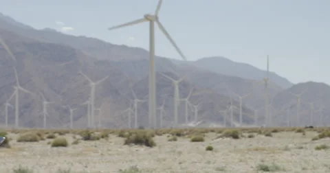 Pan to wind farm tech with computer who looks up and smiles 4K Stock Footage 63778219