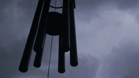 Pan of windchine with rain cloud storm in the background. Stock Footage 79516145