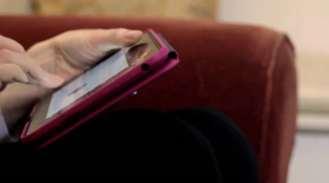 Pan to woman using tablet computer Stock Footage 20486439