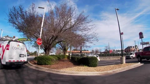 Pan by Xfinity communications work van and traffic Stock Footage 221591442
