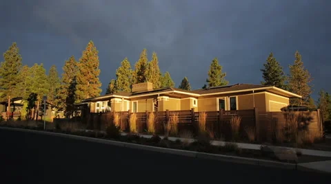PAN UP ON ZERO NET ENERGY HOME WITH GOLDEN LIGHT Stock Footage 52551697