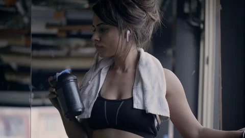 PANA0526-1 A tired young Indian female drinking protein shake after the workout. Stock Footage