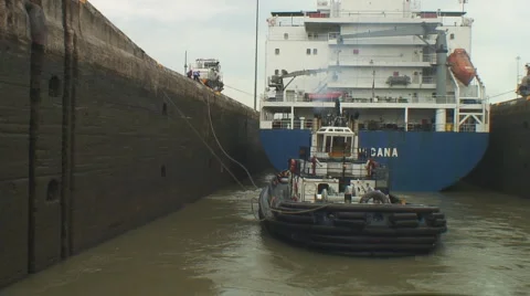 Panama Canal: Lock workmen secure tug lines Stock Footage 1040347