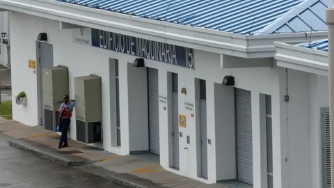 Panamanian worker standing in front of the Machine Building in Agua clara locks Stockbeeldmateriaal 121458543