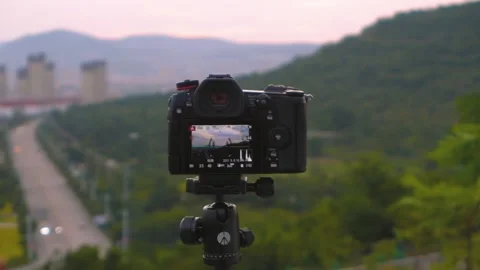 A Panasonic G9 camera mounted on a Manfrotto tripod for a time-lapse landscape v Stock Footage 160877221