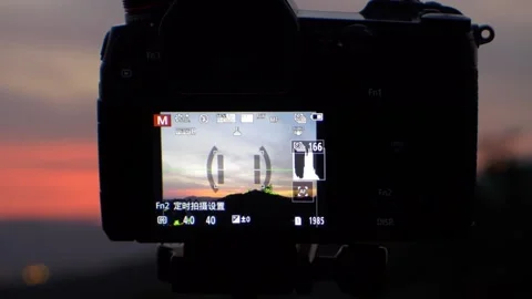 A Panasonic G9 camera mounted on a Manfrotto tripod for a time-lapse landscape v Stock Footage 160877228