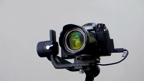 A Panasonic G9 mirrorless camera mounted on an electronic gimbal stabilizer Stock Footage 160877204
