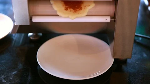Pancake from baking machine drop to the dish Stock Footage 91644295