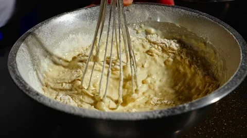 The pancake batter is almost ready. Add flour to make it thicker. Stock Footage 264400367