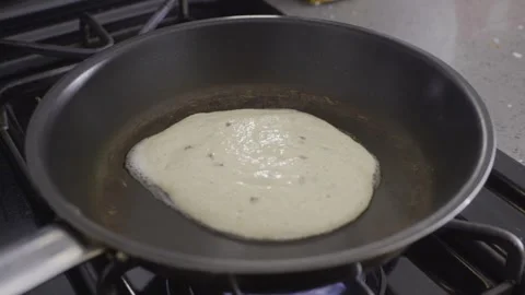 Pancake batter being poured on a pan with butter already on it. Pancake cooking 스톡 동영상 328963799