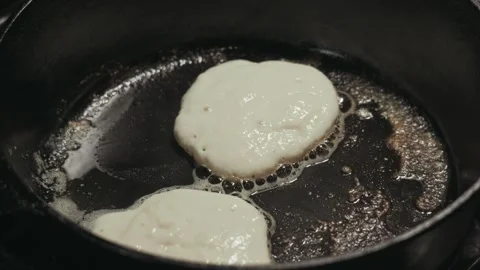Pancake batter cooks in hot cast iron skillet Stock-Footage 342002148