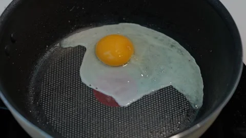 Pancake Batter Frying in Black Pan with Hand Cooking Fried Egg and Golden Stock Footage 346095286