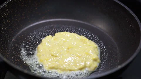 Pancake Batter / Mix Dropping From A Spoon Into A Frying Pan. Stock Footage 160117215