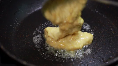 Pancake Batter / Mix Dropping From A Spoon Into A Frying Pan. Stock Footage 160118684