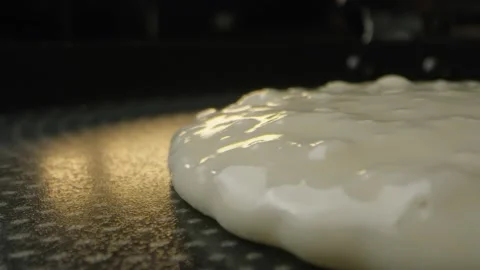 A pancake is being fried in a pan Stock Footage 141890327