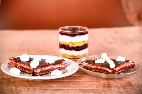 Pancake cake with fresh raspberry, pistachios and dark chocolate Stock Photos