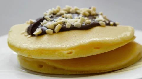 Pancake with chocolate cream and nuts Stock Footage 54339414