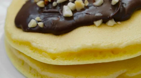 Pancake with chocolate cream and nuts, closeup Stock Footage 54339986