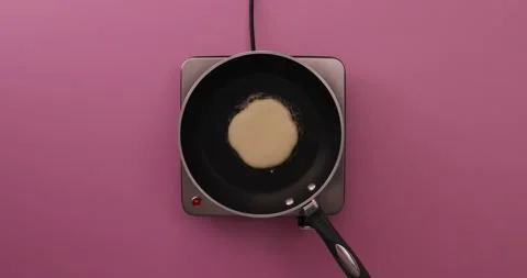 Pancake cooking in a pan Stock Footage 132148697