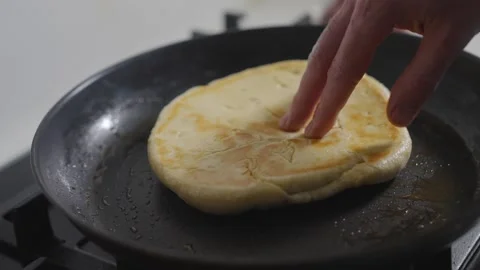 A pancake is cooking on a pan Stock Footage 306043358