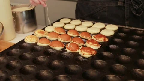 Pancake dough is poured into special cells Stock Footage 290201535