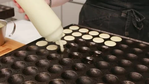 Pancake dough is poured into special cells Stock Footage 290201536