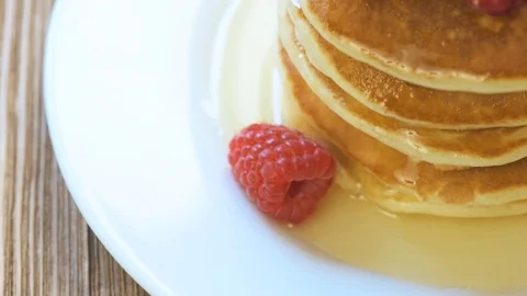 Pancake folded stack of with liquid honey and fresh blueberries Stock Footage 73078328