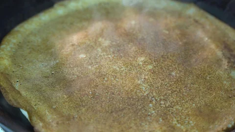 The pancake is fried in a frying pan Stock Footage 85950523