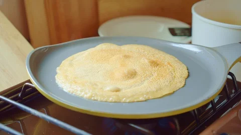 Pancake fried on gray pan in kitchen. Steam comes. Home cooking. Close up. Stock Footage 127965975