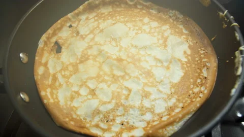 Pancake is fried in a pan. Video stock 231366692