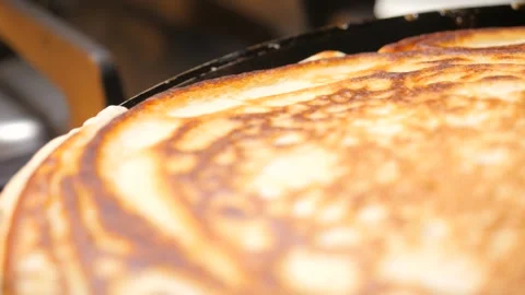 Pancake frying on a frying pan Video stock 242096563
