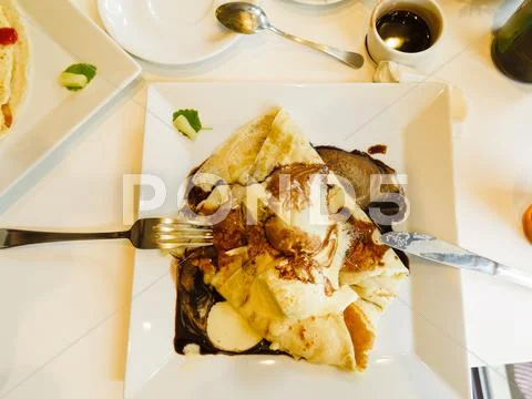 Pancake with ice cream and chocolate sauce Stock Photos