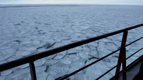 Pancake ice on surface outside the ship. Handrails of a moving ship against Stock Footage 274050005