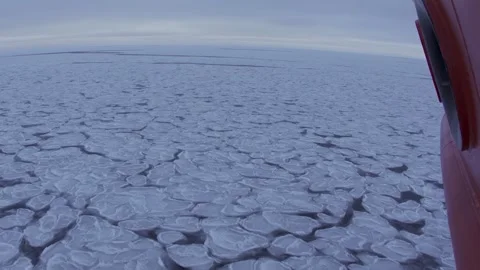 Pancake ice on surface outside vessel. Side of a moving ship above frozen sea in Stock Footage 274050171