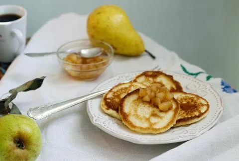 Pancake with pear compote, breakfast. Rustic style, selective focus. Foto stock