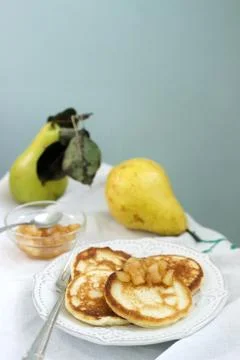 Pancake with pear compote, breakfast. Rustic style, selective focus. Stock Photos