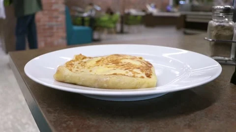 Pancake on on a plate on a table in a restaurant. 스톡 동영상 240033168