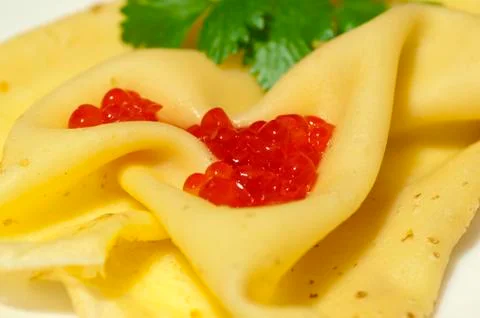 Pancake with red caviar Stock Photos