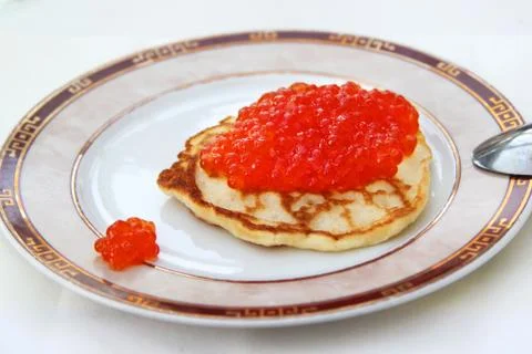 Pancake with red caviar Stock Photos