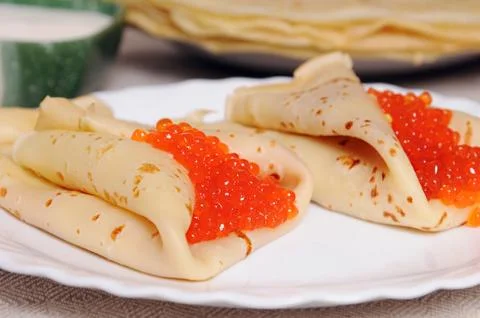 Pancake with red caviar Stock Photos