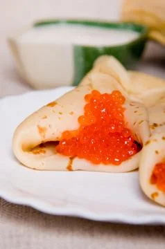 Pancake with red caviar Stock Photos