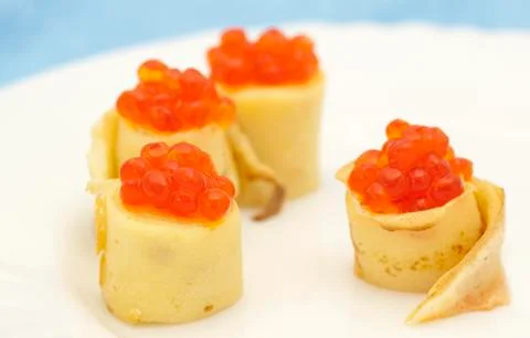 Pancake roll with red caviar Stock Photos